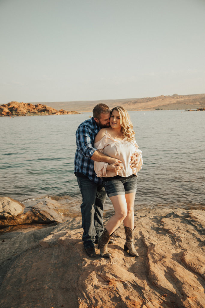 Couple posing next to a lake for a couples session