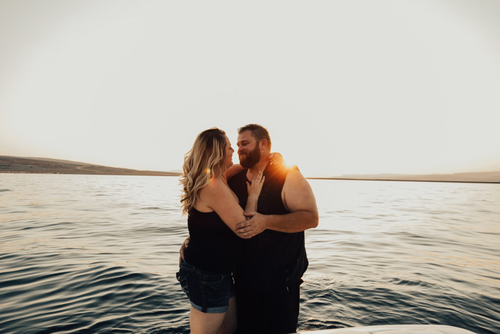 Couple holding each other in a sexy way at sunset