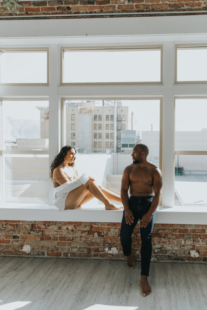 Couple hanging out in the window