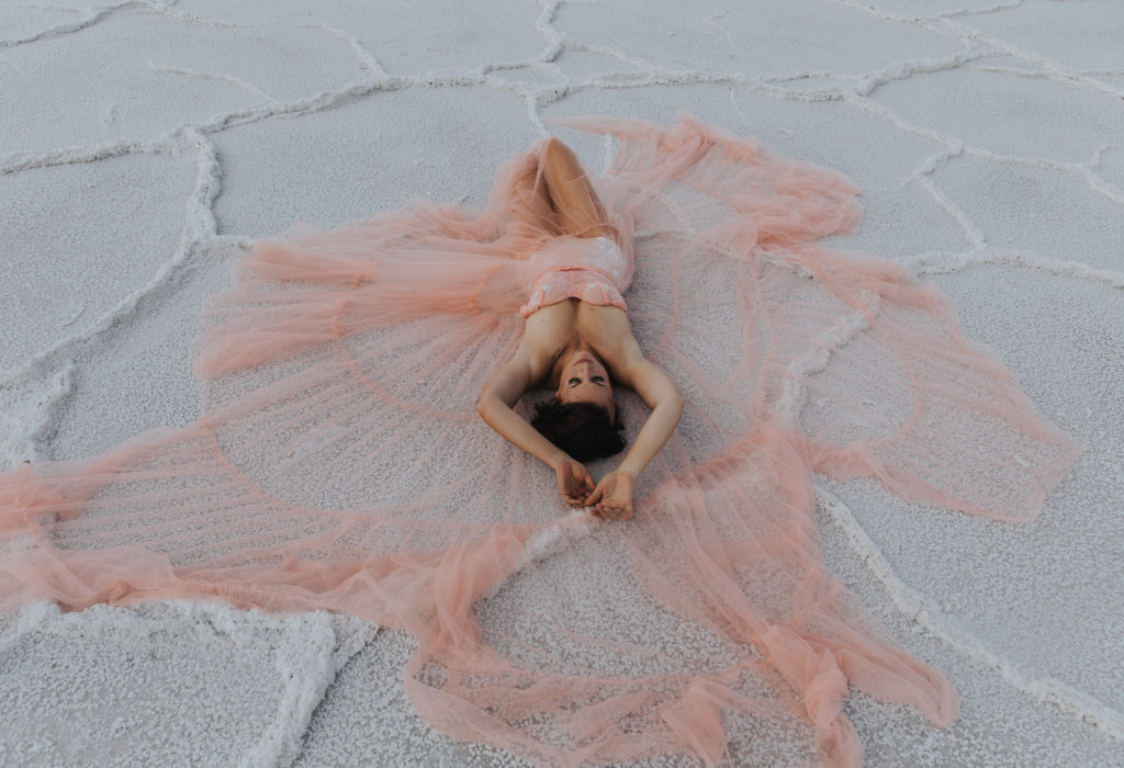 woman in a huge pink gown on the bonneville salt flats